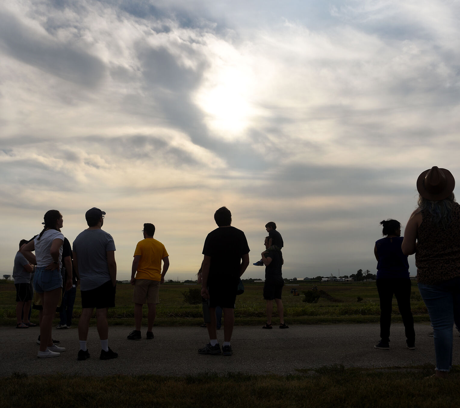 Spectators watch a weather balloon rise into the sky